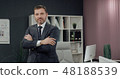 Businessman standing, office interior on background, man in suit. 48188539