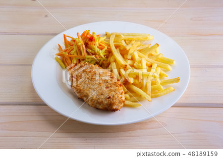 Fried meat in breading with french fries Fried meat in breading with french fries 48189159