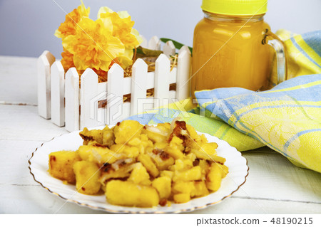 Fried potatoes on the dinner table. 48190215