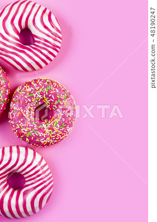 Donuts on a pink background. 48190247