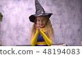 Stargazer girl rubs hands. Close up front view little witch viciously rubs her hands 48194083