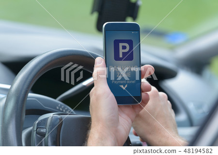Driver using smartphone app to pay for parking 48194582