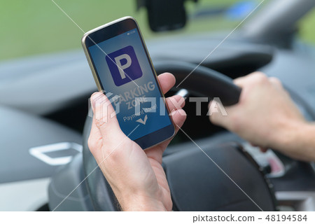 Driver using smartphone app to pay for parking 48194584
