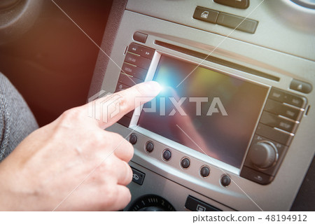 Driver using touchscreen in the car 48194912