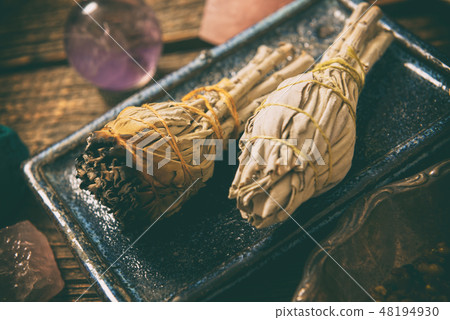 Man burning white sage incense 48194930
