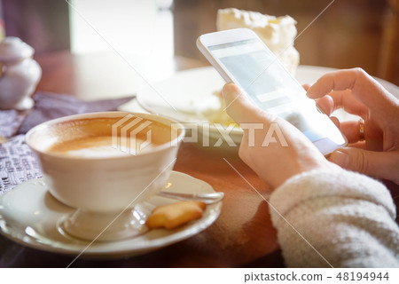 Woman using smart phone in the cafe Woman using smart phone in the cafe 48194944