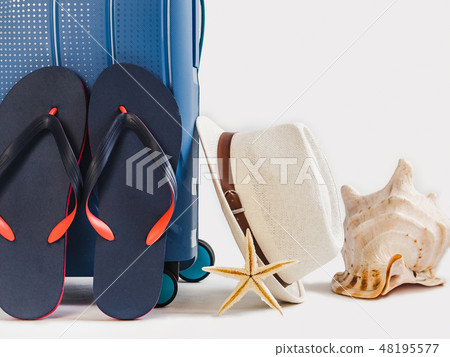 Stylish, blue suitcase, sun hat and vintage camera 48195577