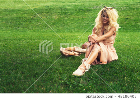eauty blonde alone young woman resting in the park 48196405
