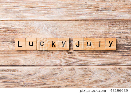 lucky july word written on wood block.  48196689