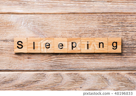 SLEEPING word written on wood block. SLEEPING word written on wood block. 48196833