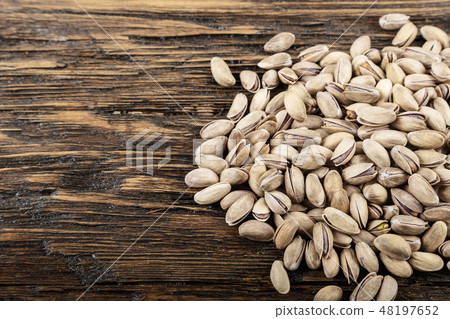 tasty pistachios lying on the table tasty pistachios lying on the table 48197652