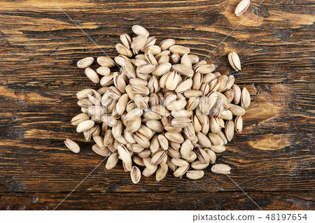 tasty pistachios lying on the table tasty pistachios lying on the table 48197654