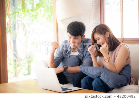 Beautiful asian couple working laptop 48200492