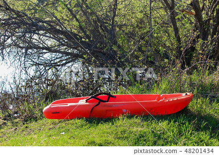 A small child kayak pulled up on the lake shore A small child kayak pulled up on the lake shore 48201434