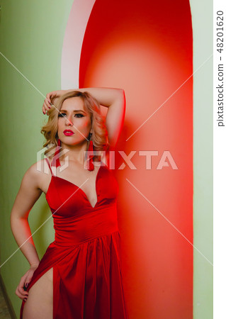 Close-up portrait of sexy blonde woman in the red dress in a studio Close-up portrait of sexy blonde woman in the red dress in a studio 48201620