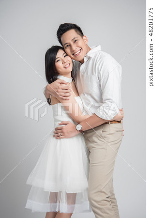 Asian couple in love embracing on white background 48201775