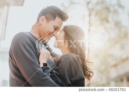 Asian couple in love embracing outdoor 48201781