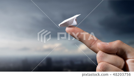 Paper plane on finger Paper plane on finger 48203756
