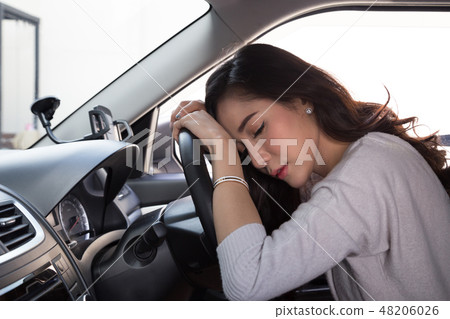 Tired young woman sleep in car Tired young woman sleep in car 48206026