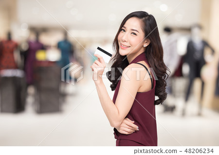 Asian women presenting credit card in hand  48206234