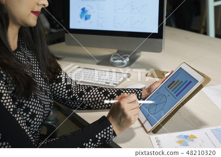 Businesswoman analyzing financial chart 48210320