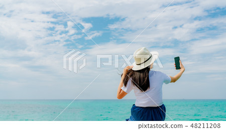 Young Asian woman use smartphone taking selfie Young Asian woman use smartphone taking selfie 48211208