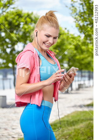 Young fit woman with phone Young fit woman with phone 48212993