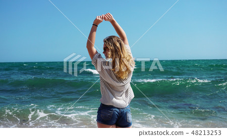 Beautiful bohemian styled and tanned girl at the beach 48213253