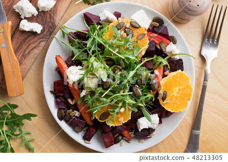 Salad with baked beets and carrots and arugula Salad with baked beets and carrots and arugula 48213305
