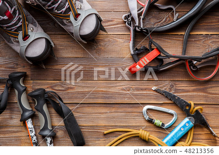 Image on top of ski poles, boots, picks on wooden background. Image on top of ski poles, boots, picks on wooden background. 48213356
