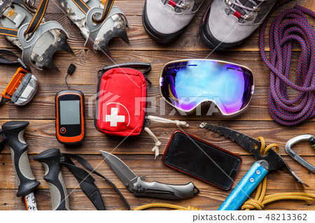 Photo from above of ski poles, boots, pickaxe, first aid kits, masks 48213362