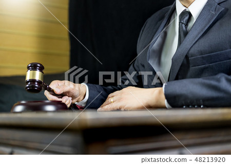 justice and law concept.Male judge in a courtroom working on woo 48213920