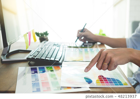 designer Editor at work drawing sketches a new project on graphi 48213937