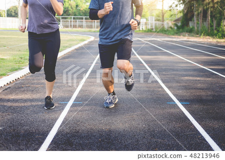 Early morning workout, Fitness couple stretching outdoors in par 48213946