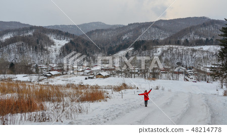 Woman walking at snow village in China Woman walking at snow village in China 48214778