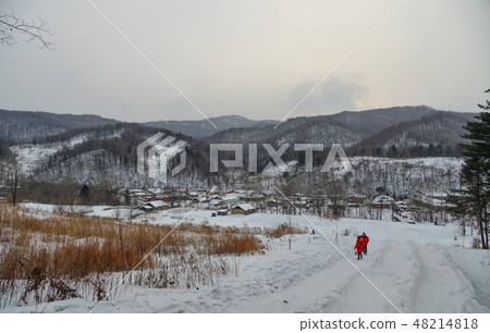 Woman walking at snow village in China Woman walking at snow village in China 48214818