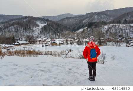 Woman walking at snow village in China 48214820
