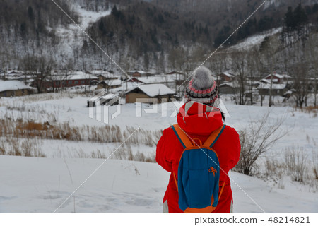 Woman walking at snow village in China Woman walking at snow village in China 48214821