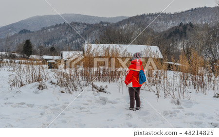 Woman walking at snow village in China 48214825