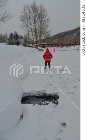 Woman walking at snow village in China Woman walking at snow village in China 48214835