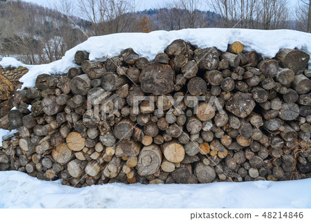 Stack of cut wood under the snow Stack of cut wood under the snow 48214846