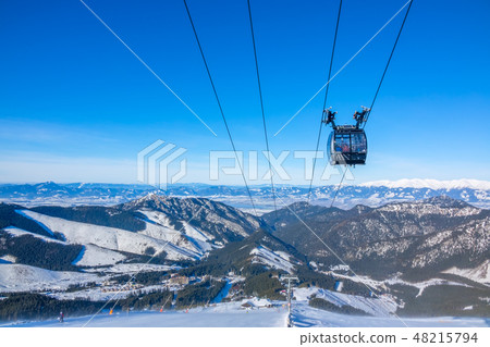 Tops of the Winter Mountains and the Cabin Skilift 48215794