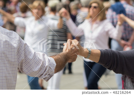 A peaceful image connecting hands. Photographed in front of Cathedral in the Gothic Quarter of Spain. Traditional dance Sardana A peaceful image connecting hands. Photographed in front of Cathedral in the Gothic Quarter of Spain. Traditional dance Sardana 48216264