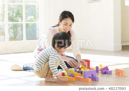 Nursery teacher, playing blocks 48217093