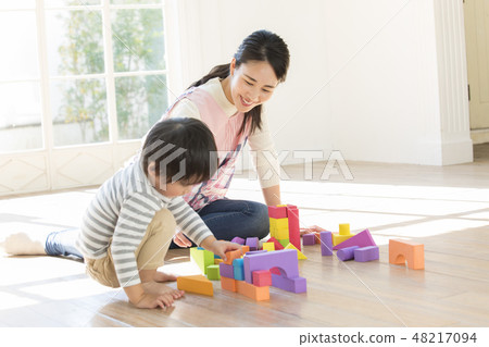 Nursery teacher, playing blocks 48217094