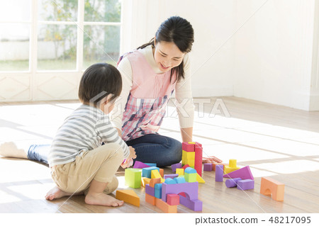 Nursery teacher, playing blocks 48217095