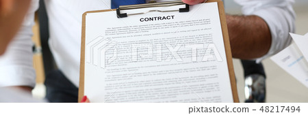 Male arm offer contract form on clipboard pad 48217494