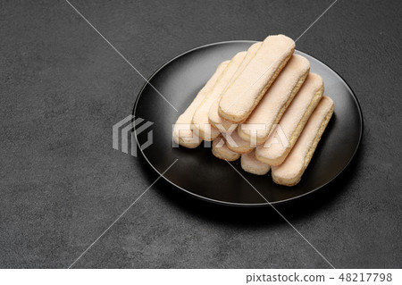 Italian Savoiardi ladyfingers Biscuits on concrete backgound 48217798