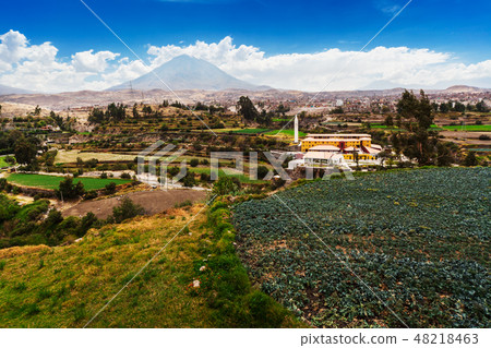 city against the backdrop of sleeping volcano 48218463