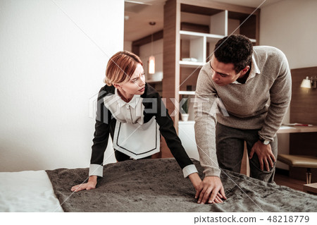 Blonde housekeeper feeling scared while client flirting with her Blonde housekeeper feeling scared while client flirting with her 48218779